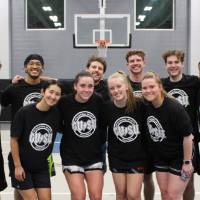 Students wearing championship shirts from a coed basketball tournament